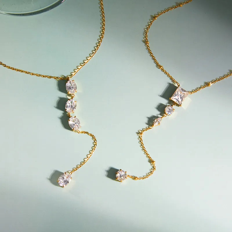 The Aria PVD Gold Linear Crystal Statement Lariat
