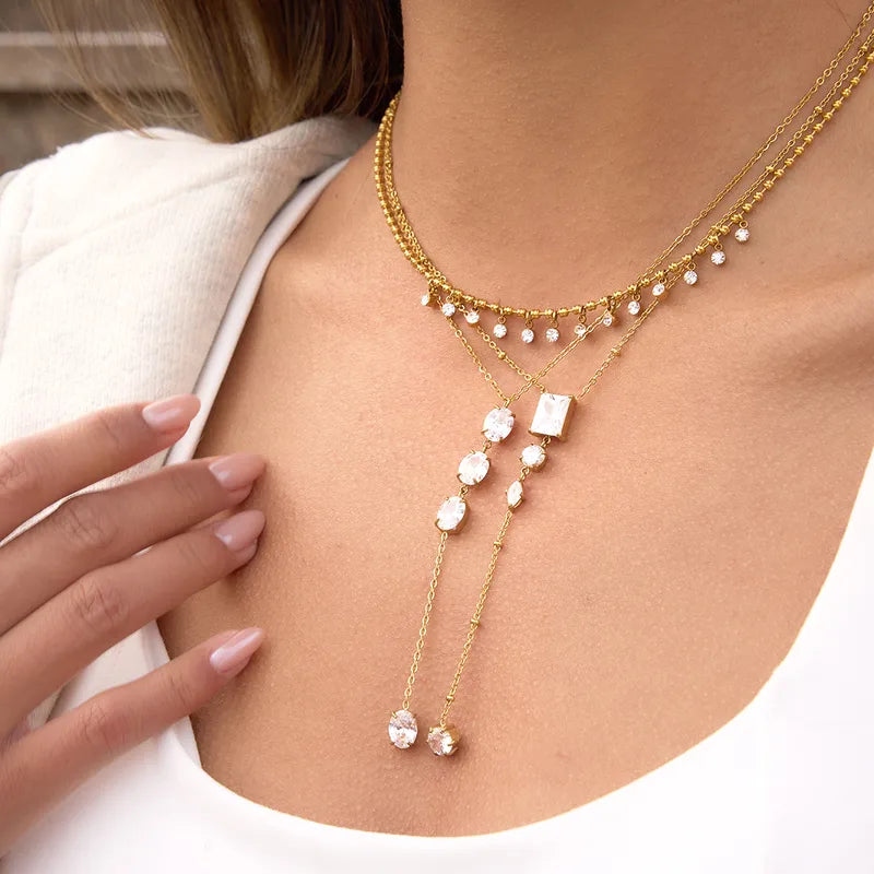 The Aria PVD Gold Linear Crystal Statement Lariat